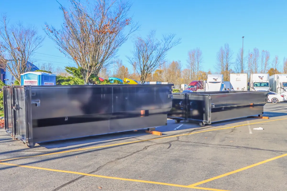 Professional dumpster rental service with roll-off container on residential driveway in Bordentown